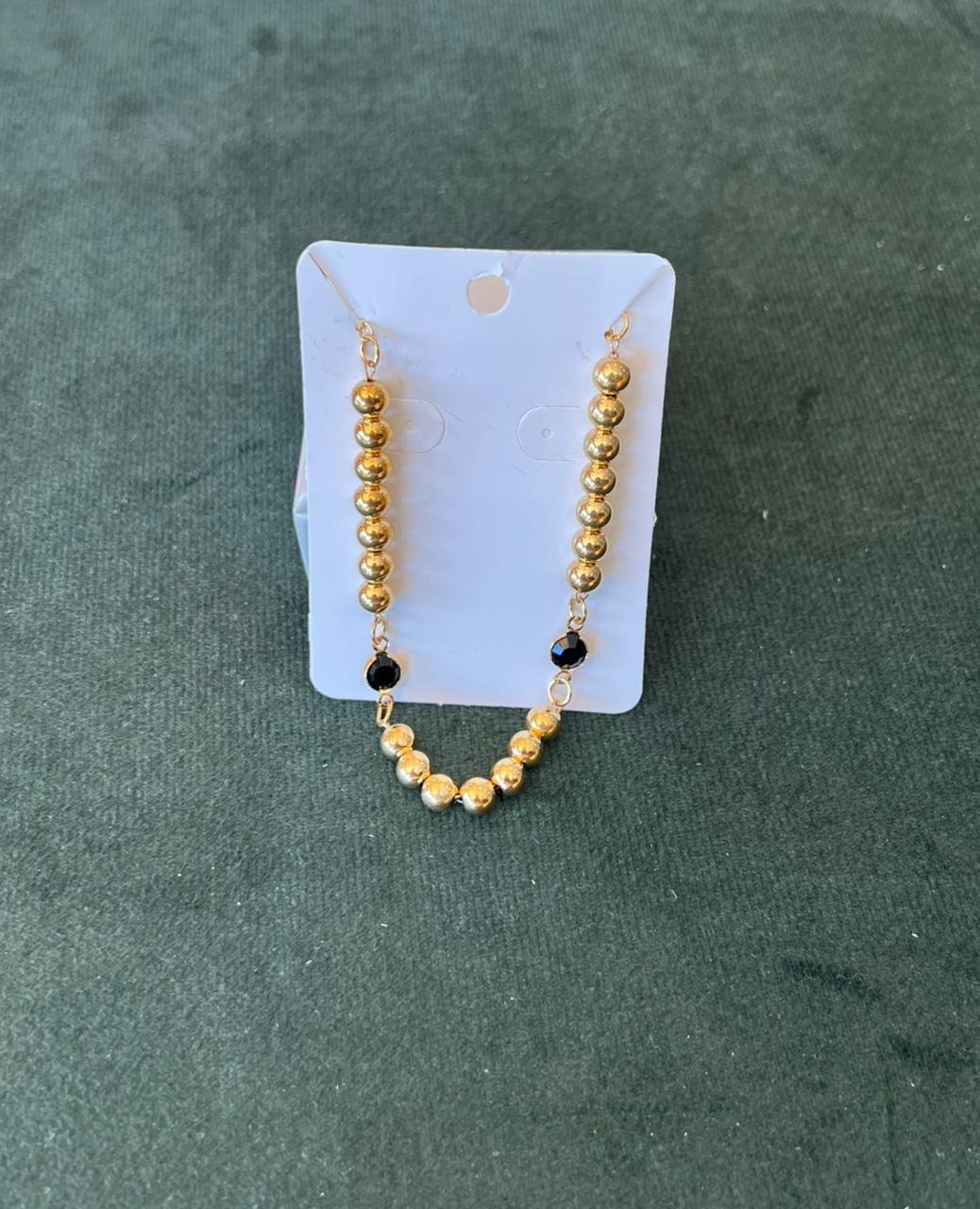 Pulseira de bolinhas dourada com bola preta